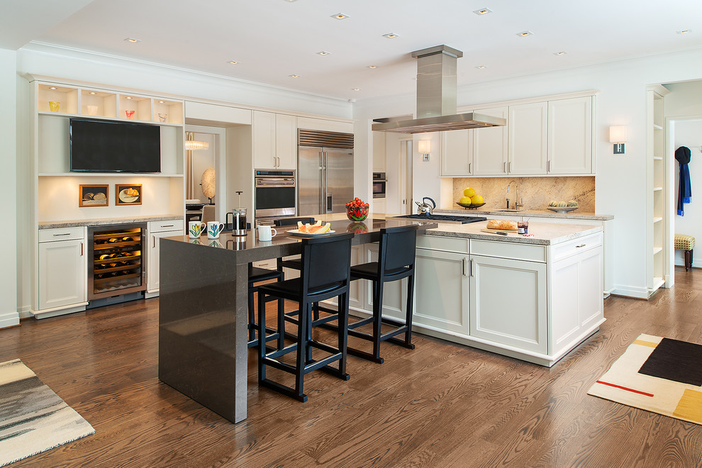 Inspiration for a transitional l-shaped eat-in kitchen in DC Metro with recessed-panel cabinets, white cabinets, beige splashback, stainless steel appliances, dark hardwood floors and with island.