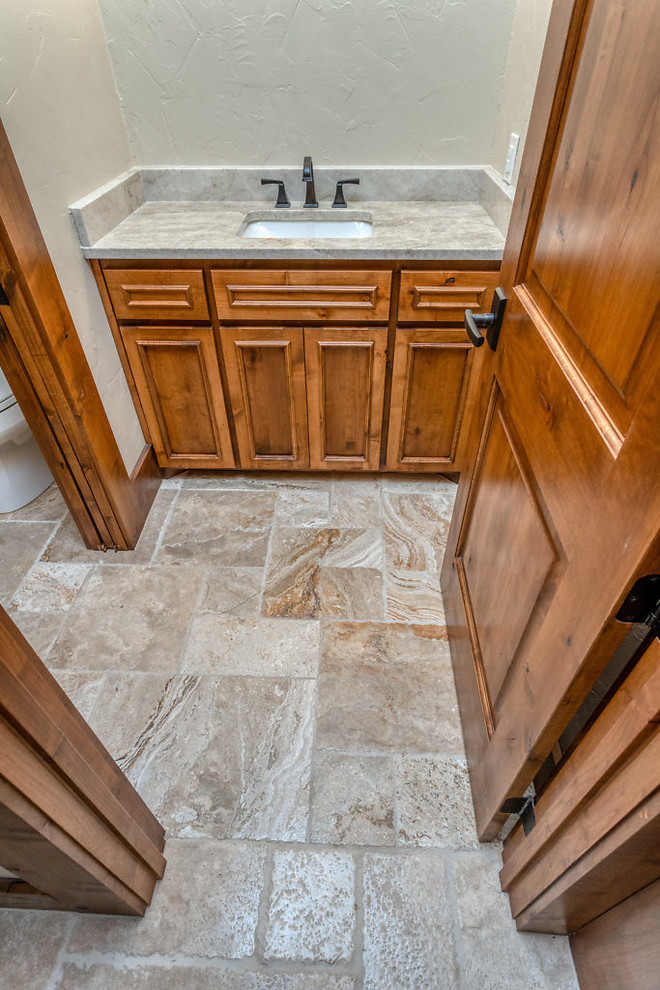 Photo of a large country master bathroom in Dallas with raised-panel cabinets, medium wood cabinets, an alcove shower, beige tile, travertine, white walls, travertine floors, an undermount sink, marble benchtops, beige floor, an open shower and grey benchtops.