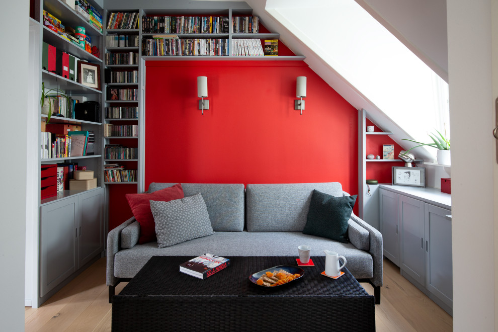 Inspiration for a small retro study in Copenhagen with red walls, light hardwood flooring, a built-in desk and a feature wall.