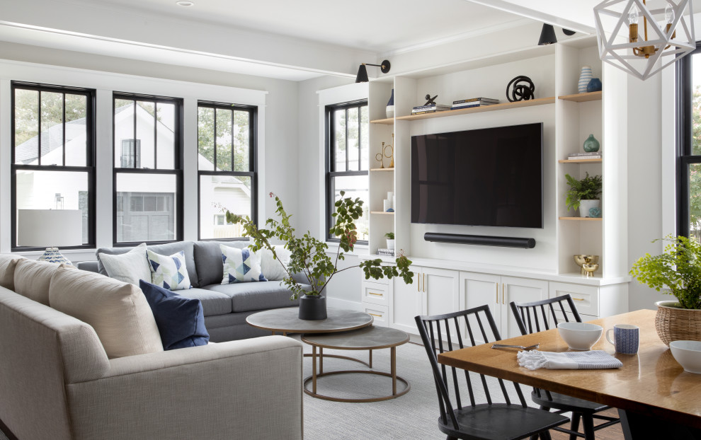 Example of a transitional open concept dark wood floor and brown floor family room design in DC Metro with gray walls and a media wall