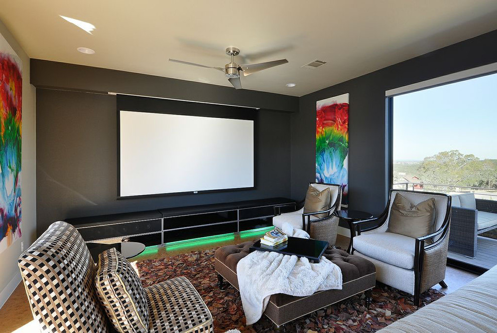Contemporary enclosed home theatre in Austin with black walls and a projector screen.