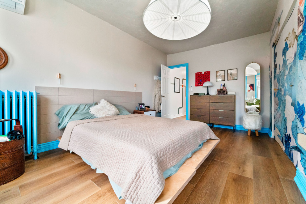 Foto di una piccola camera matrimoniale eclettica con pareti beige, pavimento in vinile, pavimento marrone e soffitto a volta