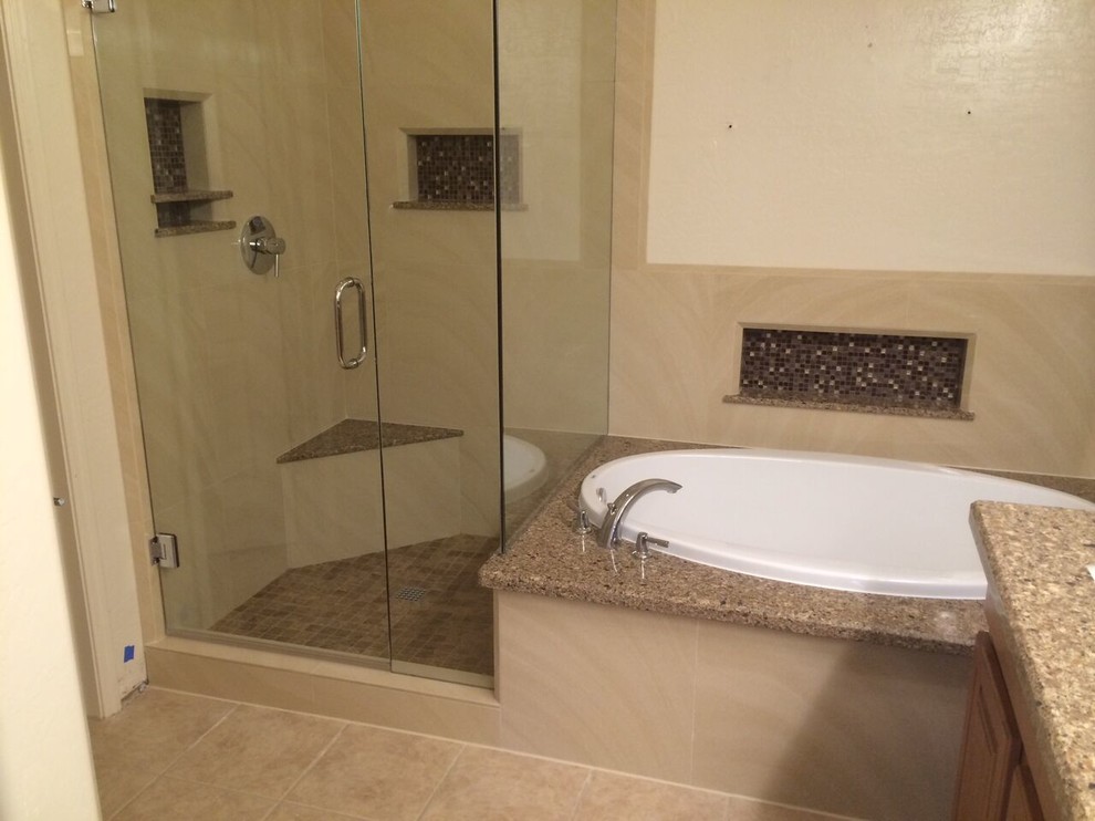 Mid-sized mountain style master beige tile and porcelain tile ceramic tile and beige floor drop-in bathtub photo in Phoenix with raised-panel cabinets, medium tone wood cabinets, beige walls, terrazzo countertops and a hinged shower door