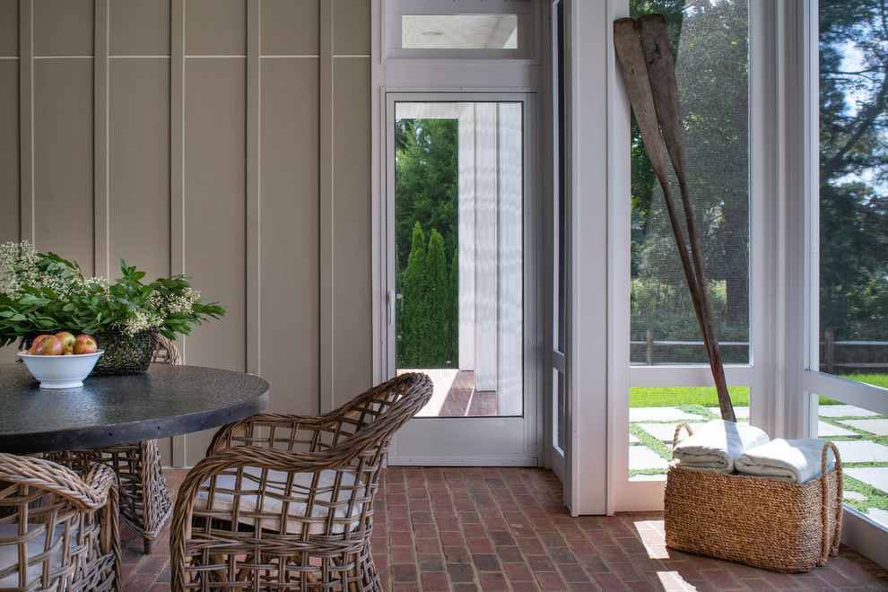 Design ideas for a mid-sized country side yard screened-in verandah in DC Metro with brick pavers.