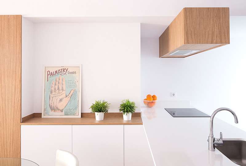 Medium sized modern galley kitchen/diner in Valencia with a submerged sink, flat-panel cabinets, white cabinets, stainless steel appliances, ceramic flooring, a breakfast bar and grey floors.