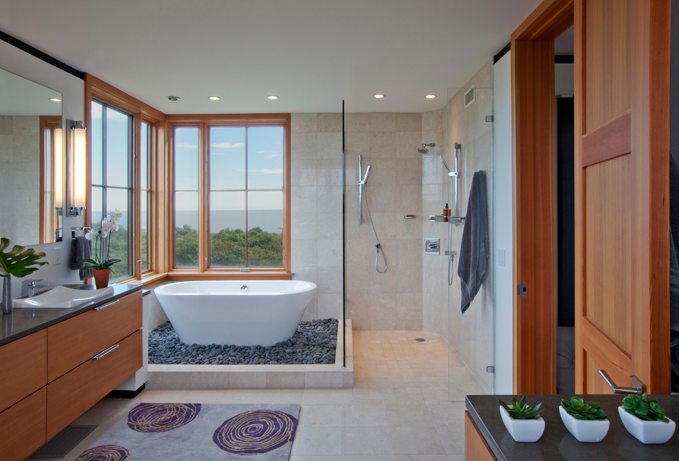 This is an example of a contemporary bathroom in Boston with a vessel sink, flat-panel cabinets, medium wood cabinets, a freestanding tub, an open shower, beige tile and an open shower.
