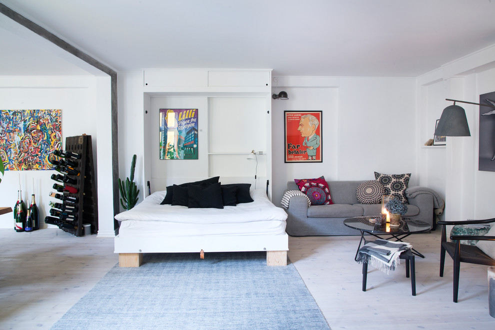 Photo of a mid-sized scandinavian living room in Copenhagen with white walls, light hardwood floors and white floor.