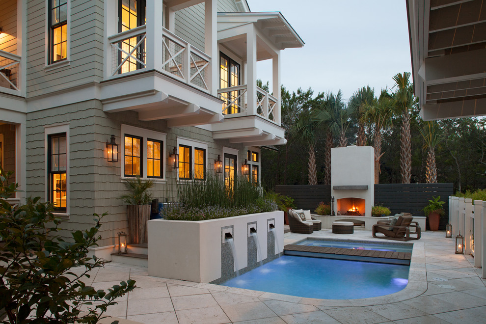 This is an example of a traditional custom-shaped pool in Miami with concrete pavers and a water feature.