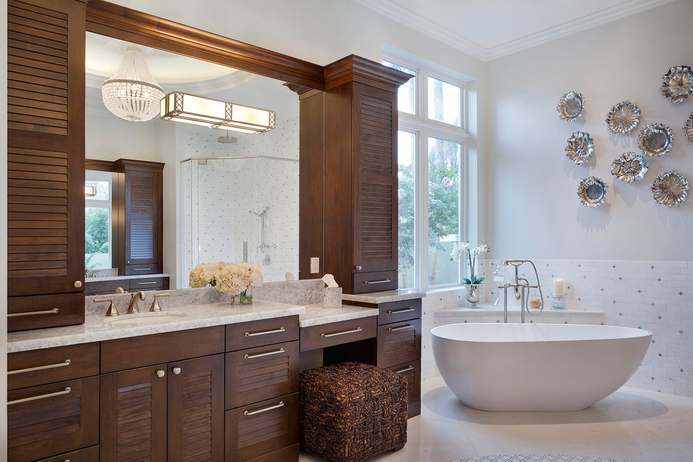 Inspiration for a large transitional master multicolored tile and porcelain tile porcelain tile and beige floor freestanding bathtub remodel in Miami with louvered cabinets, dark wood cabinets, a one-piece toilet, gray walls, an undermount sink, marble countertops and multicolored countertops
