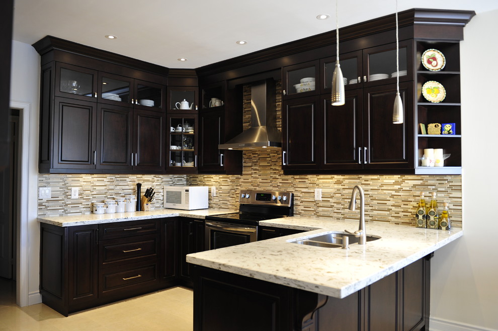 Mid-sized transitional u-shaped eat-in kitchen photo in Toronto with a double-bowl sink, raised-panel cabinets, dark wood cabinets, quartz countertops, multicolored backsplash, matchstick tile backsplash, stainless steel appliances and a peninsula