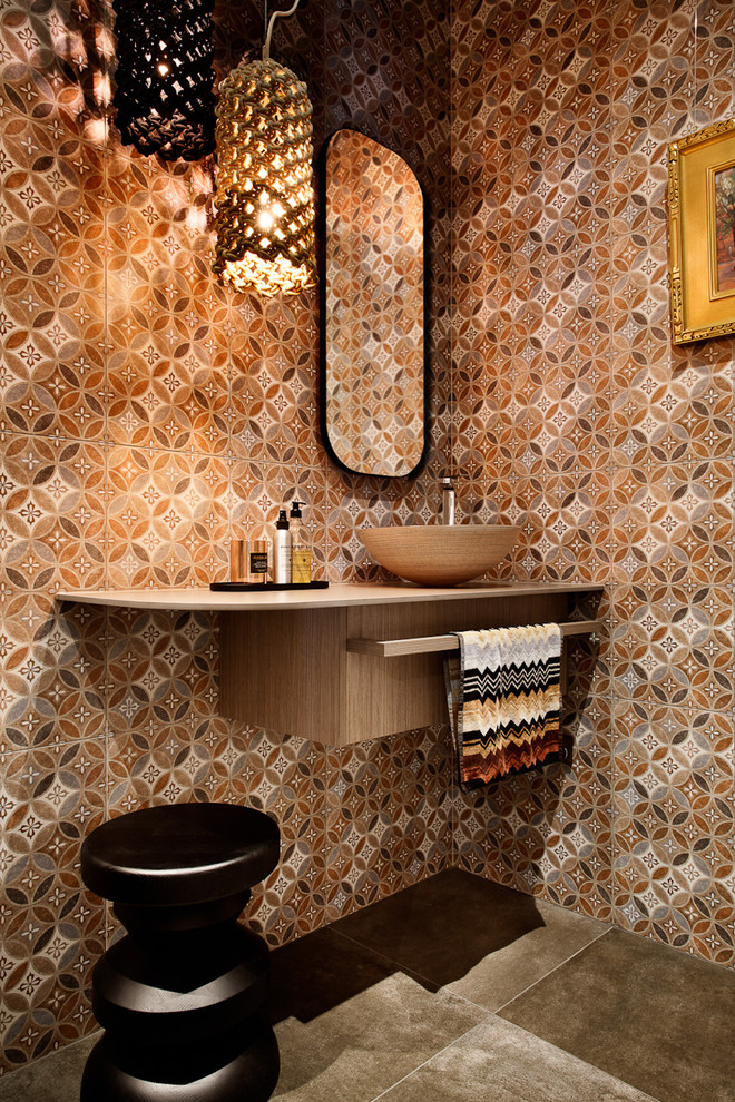 Photo of a small contemporary 3/4 bathroom in Melbourne with flat-panel cabinets, medium wood cabinets, a freestanding tub, orange tile, ceramic tile, ceramic floors, a vessel sink, engineered quartz benchtops and beige floor.