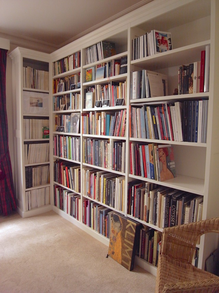 Mid-sized arts and crafts study room in London with carpet, a freestanding desk and beige floor.