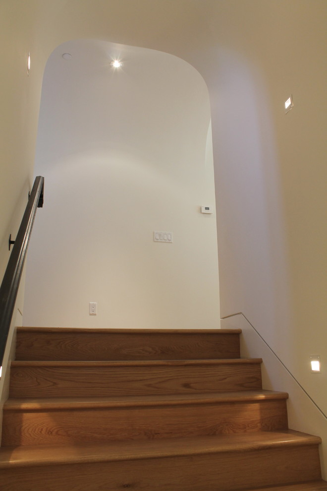 Photo of a mid-sized mediterranean wood straight staircase in San Francisco with wood risers.
