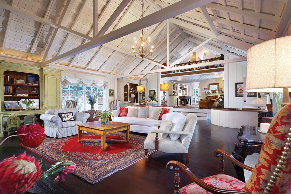 Photo of an expansive eclectic living room in Orange County with dark hardwood floors.