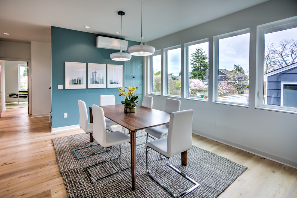 Design ideas for a mid-sized contemporary dining room in Seattle with blue walls and light hardwood floors.