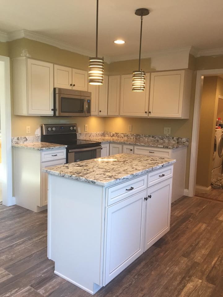 Inspiration for a mid-sized transitional ceramic tile eat-in kitchen remodel in Cincinnati with an undermount sink, flat-panel cabinets, white cabinets, granite countertops, stainless steel appliances and an island