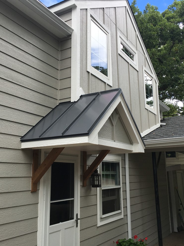 Inspiration for a small traditional two-storey grey exterior in Milwaukee with wood siding and a gable roof.