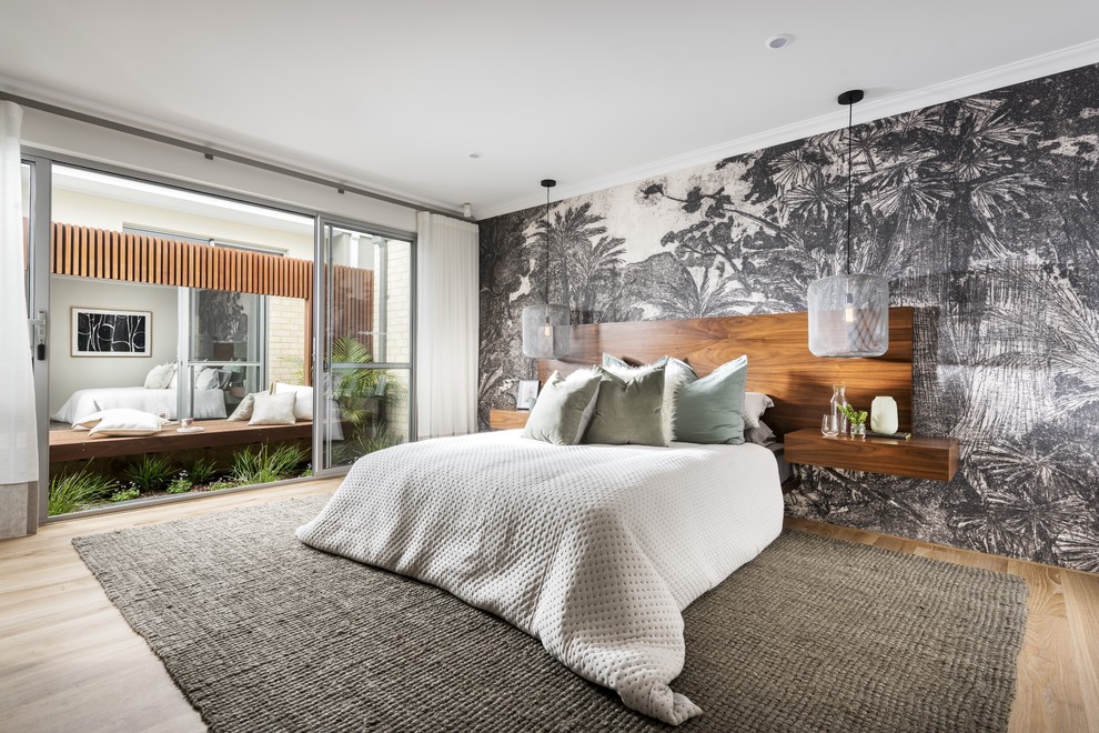 This is an example of a contemporary bedroom in Perth with white walls, medium hardwood floors and brown floor.