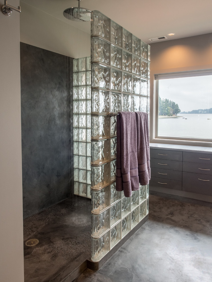 Mid-sized contemporary master bathroom in Seattle with an undermount sink, flat-panel cabinets, grey cabinets, solid surface benchtops, a double shower, a two-piece toilet, grey walls, concrete floors, grey floor, an open shower, grey benchtops, a niche, a double vanity, a built-in vanity and vaulted.