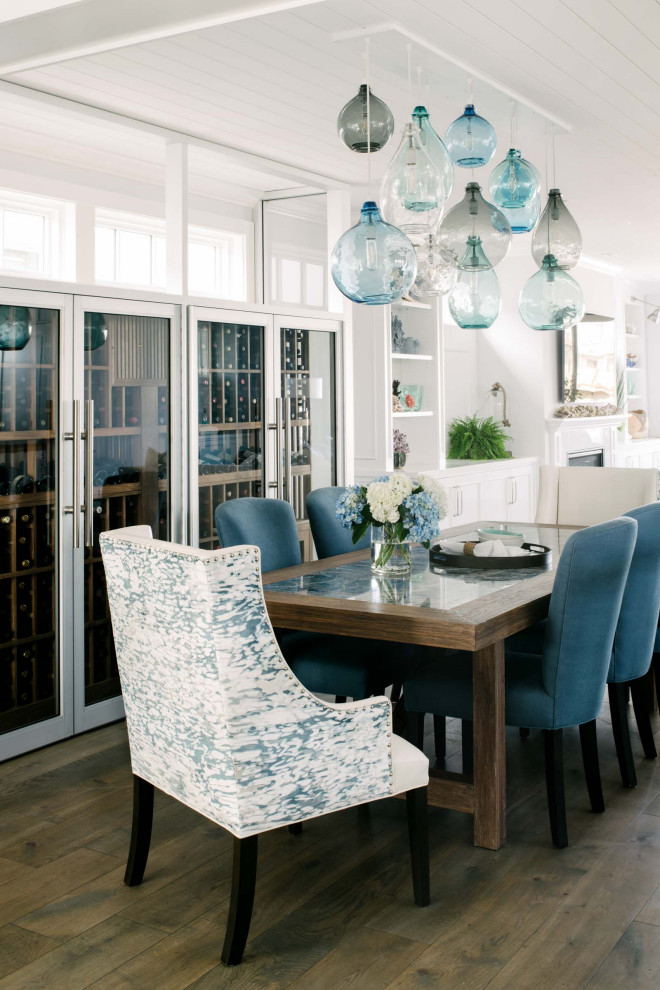 Inspiration for a beach style dining room in Los Angeles with white walls, dark hardwood floors, brown floor and timber.