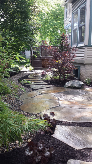 Small asian side yard patio in Chicago with natural stone pavers.