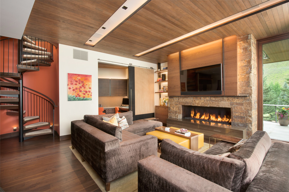 This is an example of a large contemporary open concept family room in Denver with white walls, a ribbon fireplace, a stone fireplace surround, a wall-mounted tv, brown floor and dark hardwood floors.