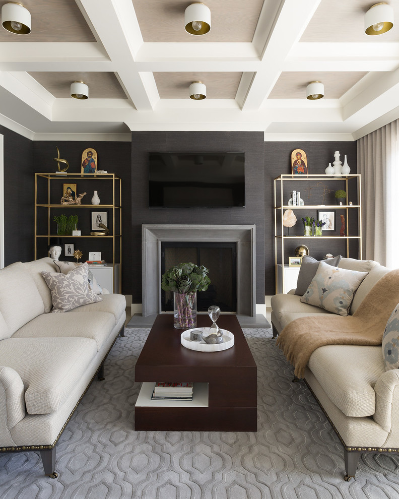 Photo of a transitional family room in Chicago with grey walls, a standard fireplace, a wall-mounted tv and grey floor.