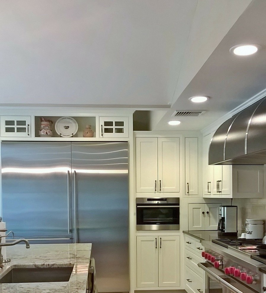 Inspiration for a transitional kitchen remodel in Minneapolis with recessed-panel cabinets, white cabinets, granite countertops and beige backsplash