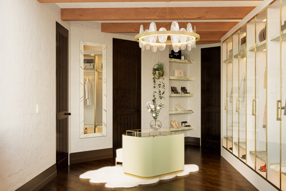 Photo of a medium sized mediterranean walk-in wardrobe for women in Los Angeles with glass-front cabinets, white cabinets, dark hardwood flooring, brown floors and exposed beams.