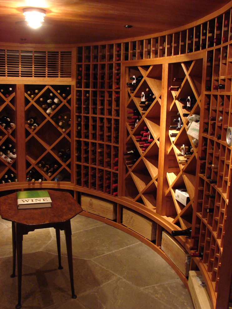 Photo of a large traditional wine cellar in New York with slate floors and diamond bins.