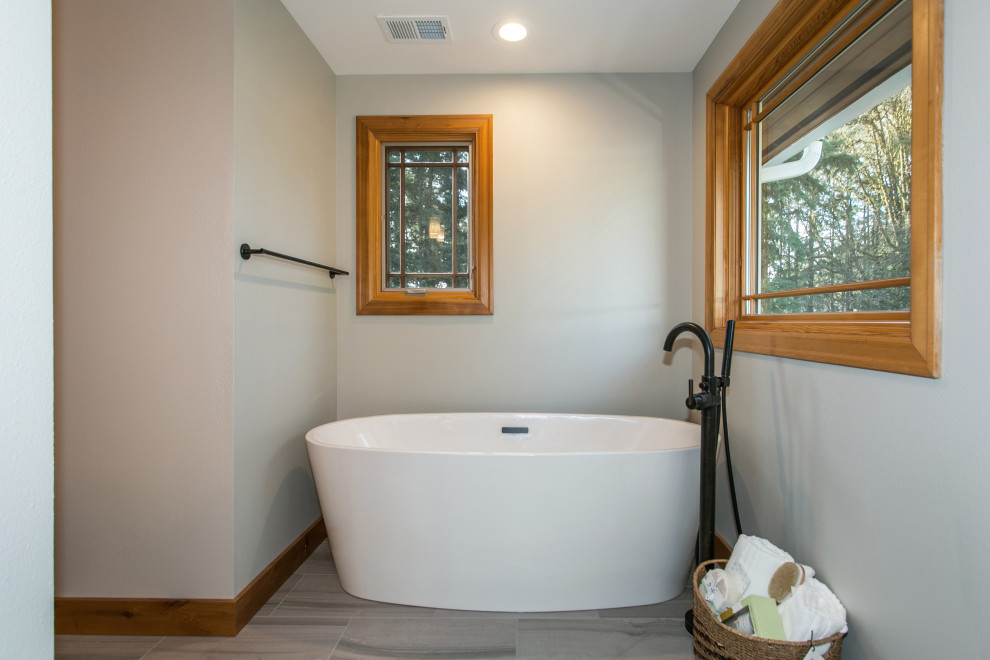 Photo of a large country master bathroom in Portland with shaker cabinets, dark wood cabinets, a freestanding tub, an open shower, a two-piece toilet, gray tile, porcelain tile, grey walls, ceramic floors, an undermount sink, quartzite benchtops, grey floor, an open shower, white benchtops, a shower seat, a double vanity and a built-in vanity.