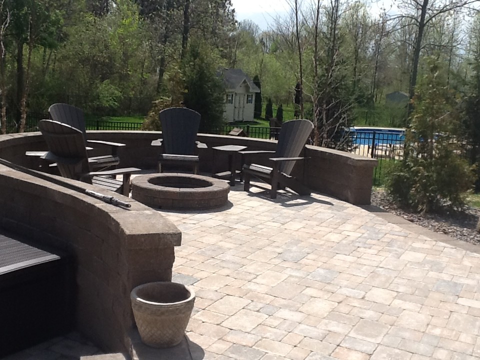 Design ideas for a large arts and crafts backyard patio in New York with a fire feature and concrete pavers.