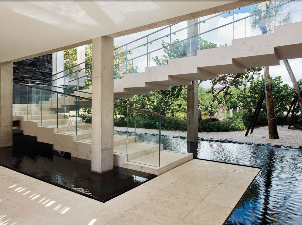 Photo of an expansive contemporary concrete floating staircase in Miami with concrete risers.