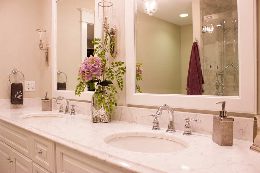 Large transitional master double-sink bathroom photo in Cedar Rapids with a drop-in sink, recessed-panel cabinets, white cabinets, quartz countertops and beige walls
