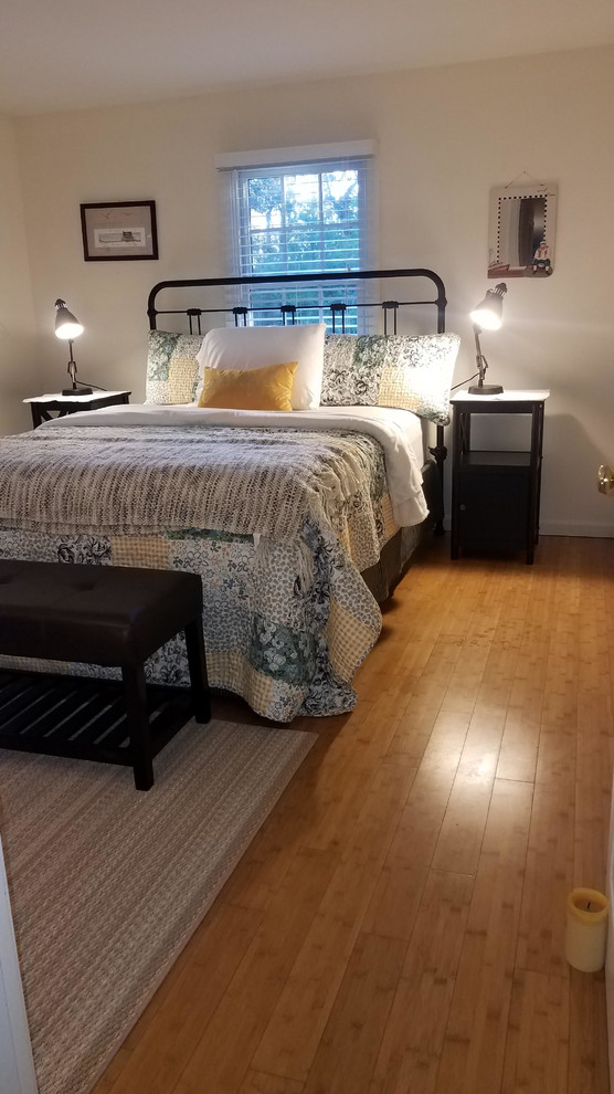 This is an example of a traditional guest bedroom in Boston with bamboo floors.