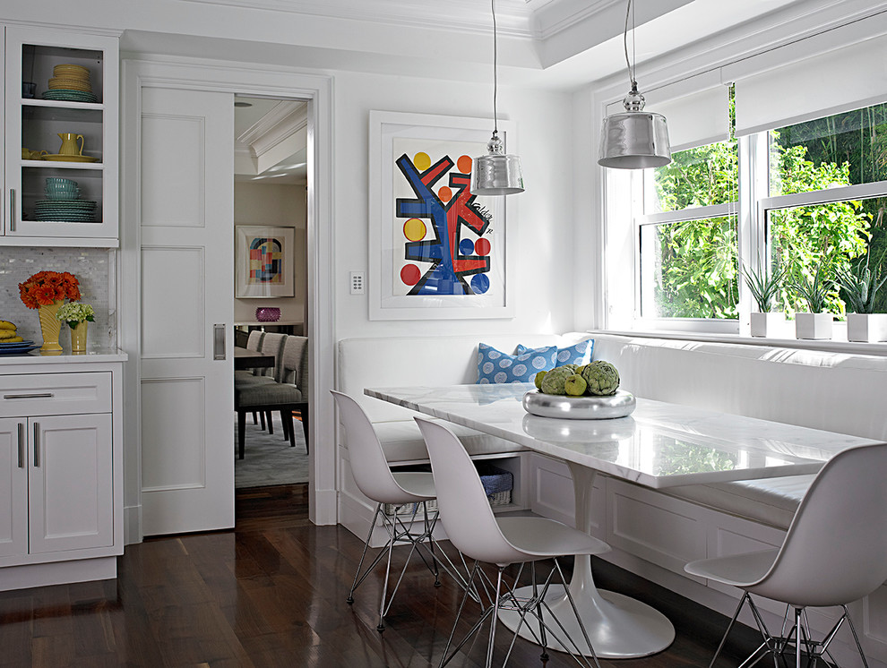 Design ideas for a transitional kitchen/dining combo in Miami with white walls, dark hardwood floors and no fireplace.