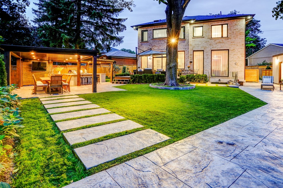 Mid-sized transitional backyard stamped concrete and rectangular pool house photo in Toronto