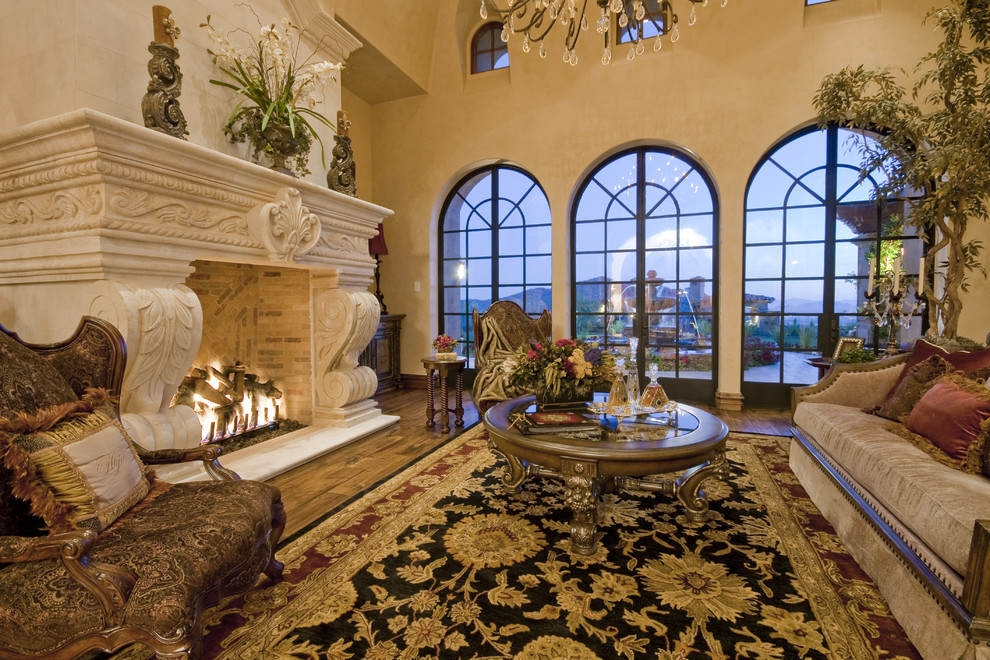Inspiration for an expansive mediterranean formal open concept living room in Phoenix with beige walls, travertine floors, a standard fireplace and a stone fireplace surround.