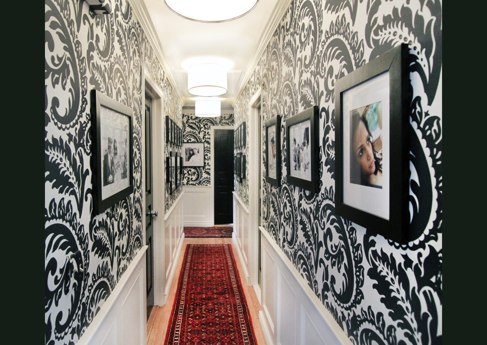Inspiration for a mid-sized traditional hallway in New York with multi-coloured walls and light hardwood floors.