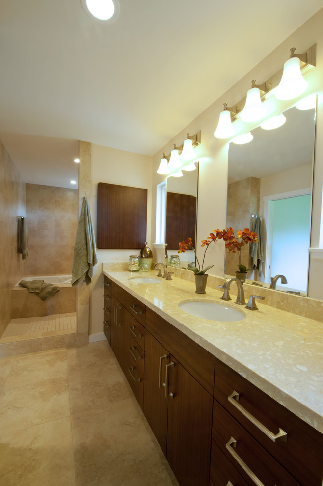 Photo of a large tropical master bathroom in Hawaii with flat-panel cabinets, dark wood cabinets, beige walls, a drop-in tub, ceramic floors, an undermount sink, granite benchtops and beige floor.