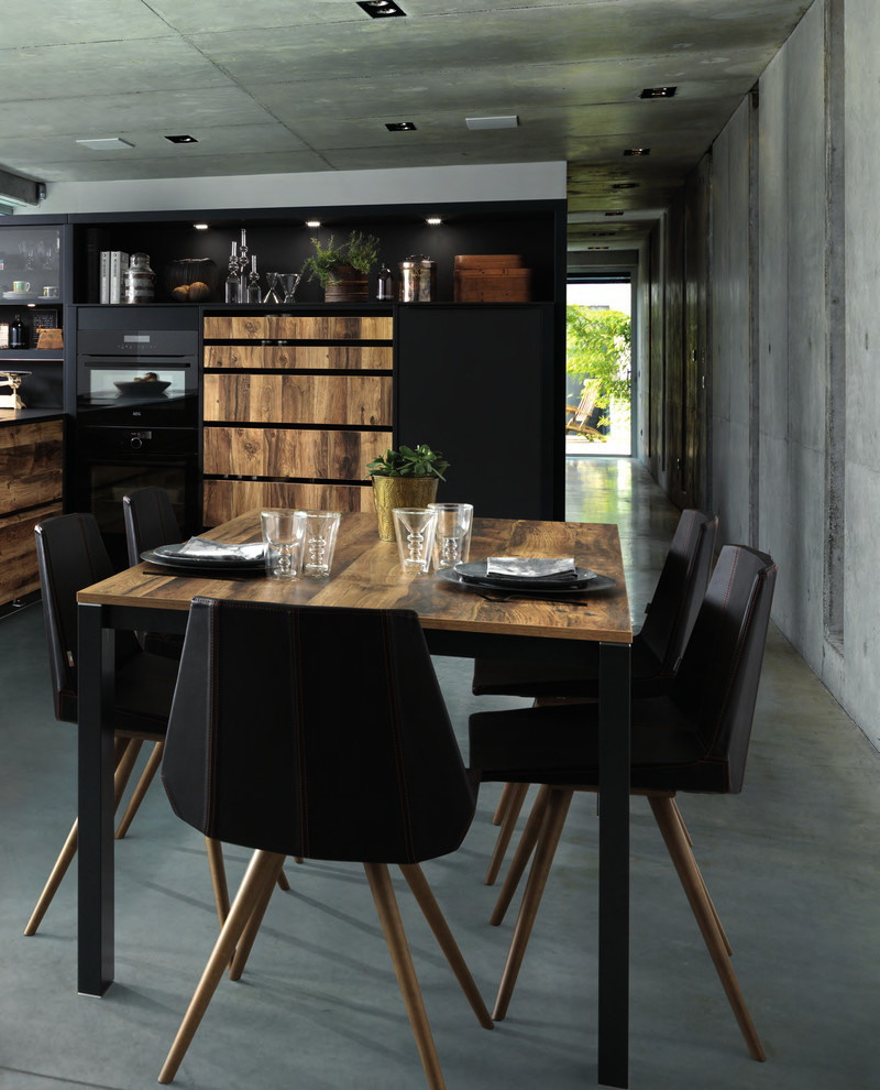 This is an example of a mid-sized contemporary dining room in London with concrete floors and grey floor.
