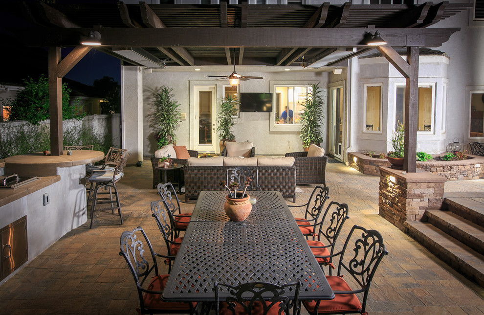 Inspiration for a large traditional backyard patio in San Diego with a fire feature, concrete pavers and a pergola.