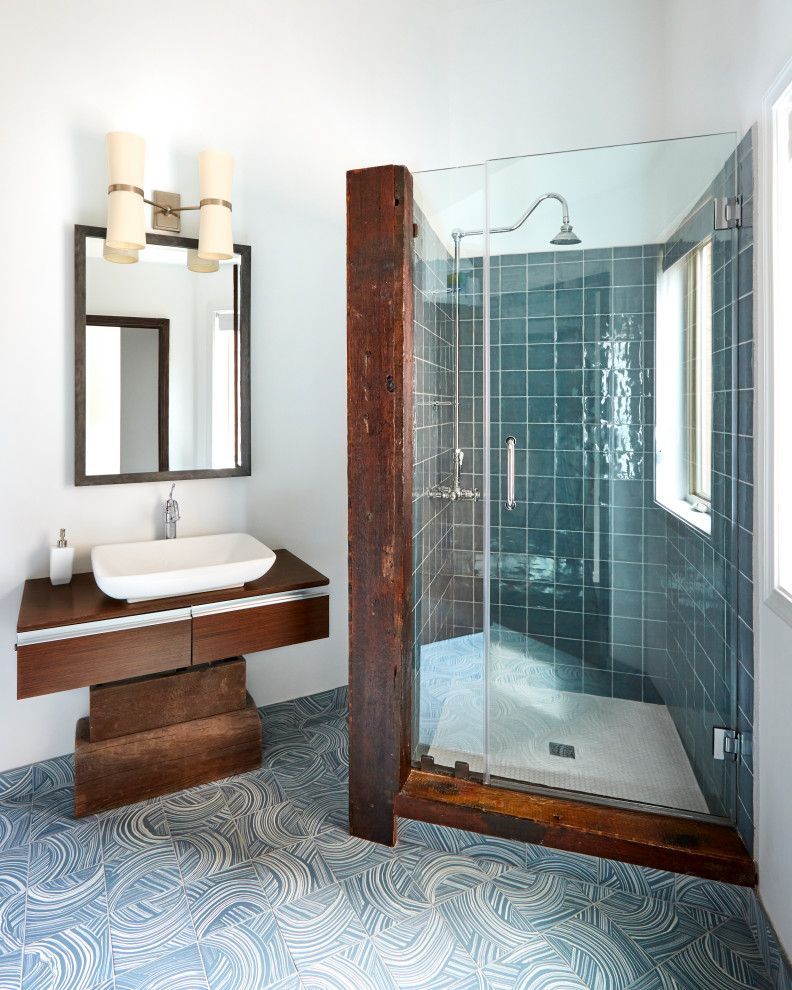 Contemporary bathroom in Philadelphia with flat-panel cabinets, dark wood cabinets, an alcove shower, blue tile, white walls, a vessel sink, wood benchtops, blue floor, a hinged shower door, brown benchtops, a single vanity and a freestanding vanity.