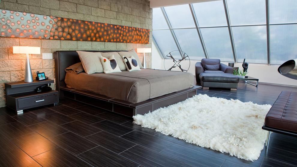 Photo of a large contemporary master bedroom in Los Angeles with a hanging fireplace.