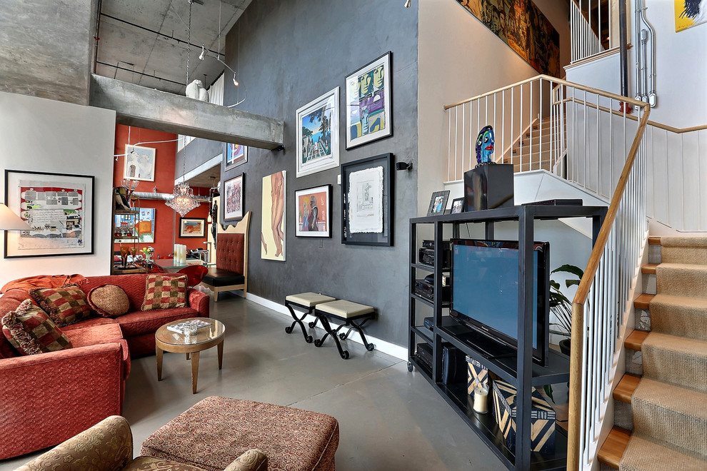 This is an example of an industrial family room in Denver with concrete floors.