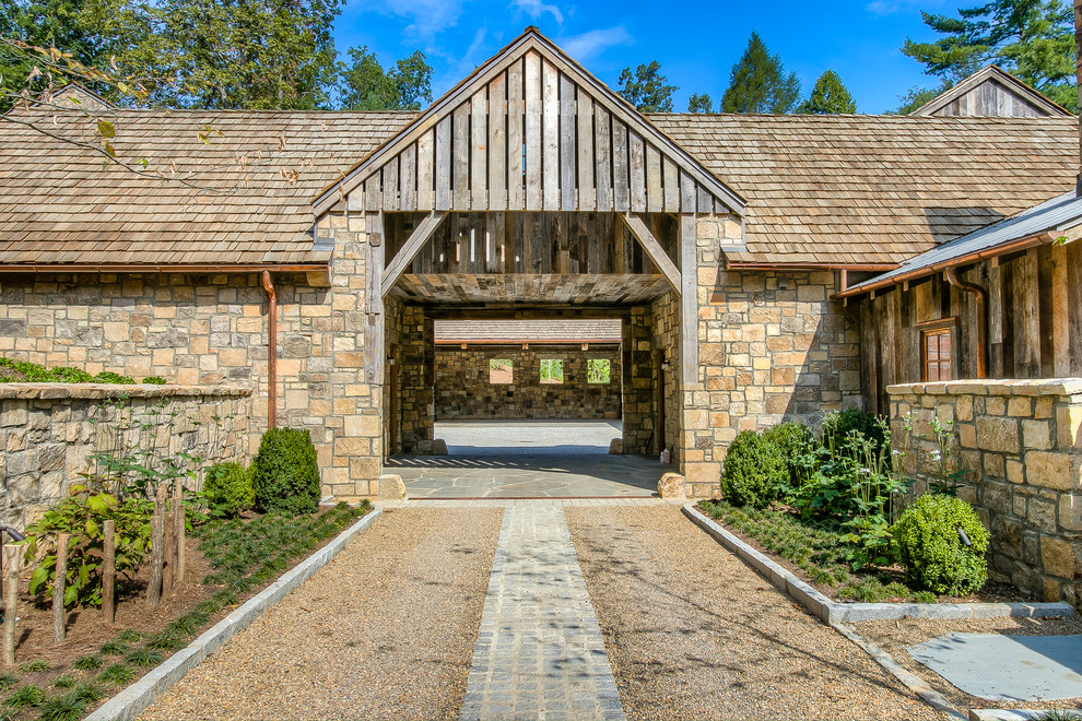 Inspiration for a rustic attached one-car porte cochere remodel