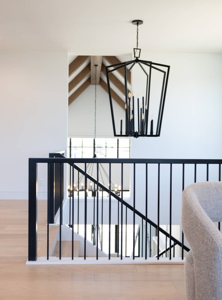Example of a large trendy wooden l-shaped open and metal railing staircase design in Calgary