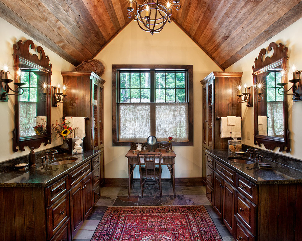 This is an example of a country master bathroom in Other with dark wood cabinets, white walls, ceramic floors, an undermount sink, granite benchtops, raised-panel cabinets, multi-coloured floor and black benchtops.