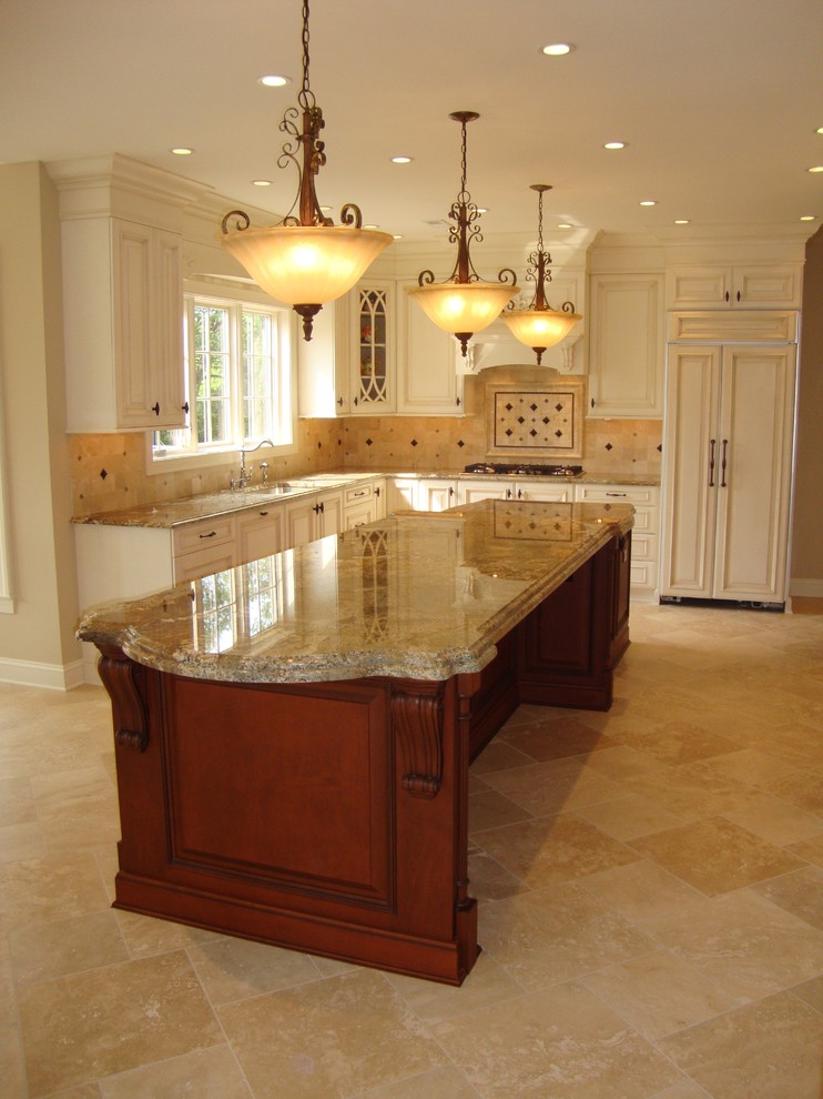 Photo of a large traditional u-shaped separate kitchen in Philadelphia with an undermount sink, raised-panel cabinets, light wood cabinets, granite benchtops, beige splashback, travertine splashback, panelled appliances, travertine floors, with island, brown floor and brown benchtop.