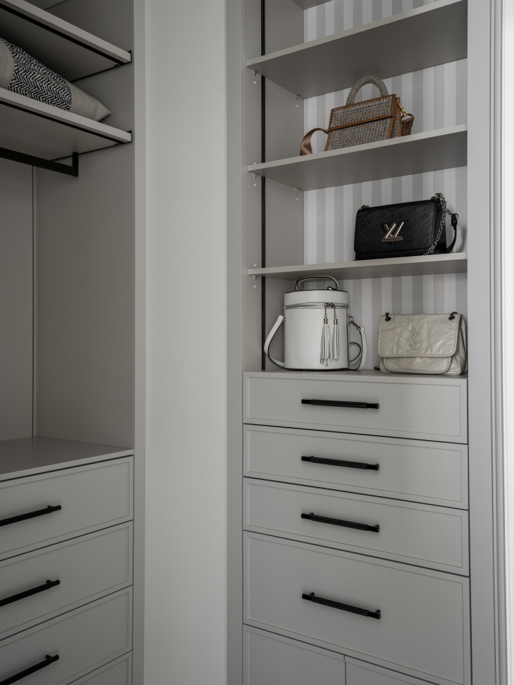 This is an example of a contemporary wardrobe in Other with open cabinets and grey cabinets.